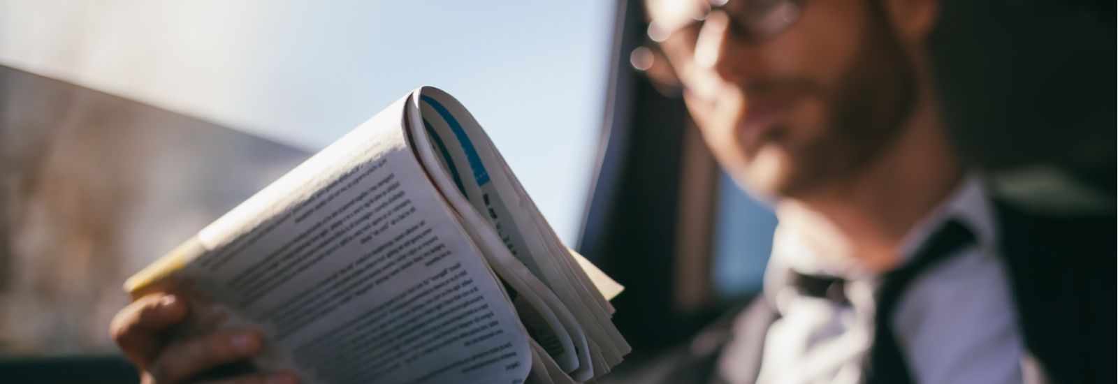 Out of focus image of man reading a newspaper