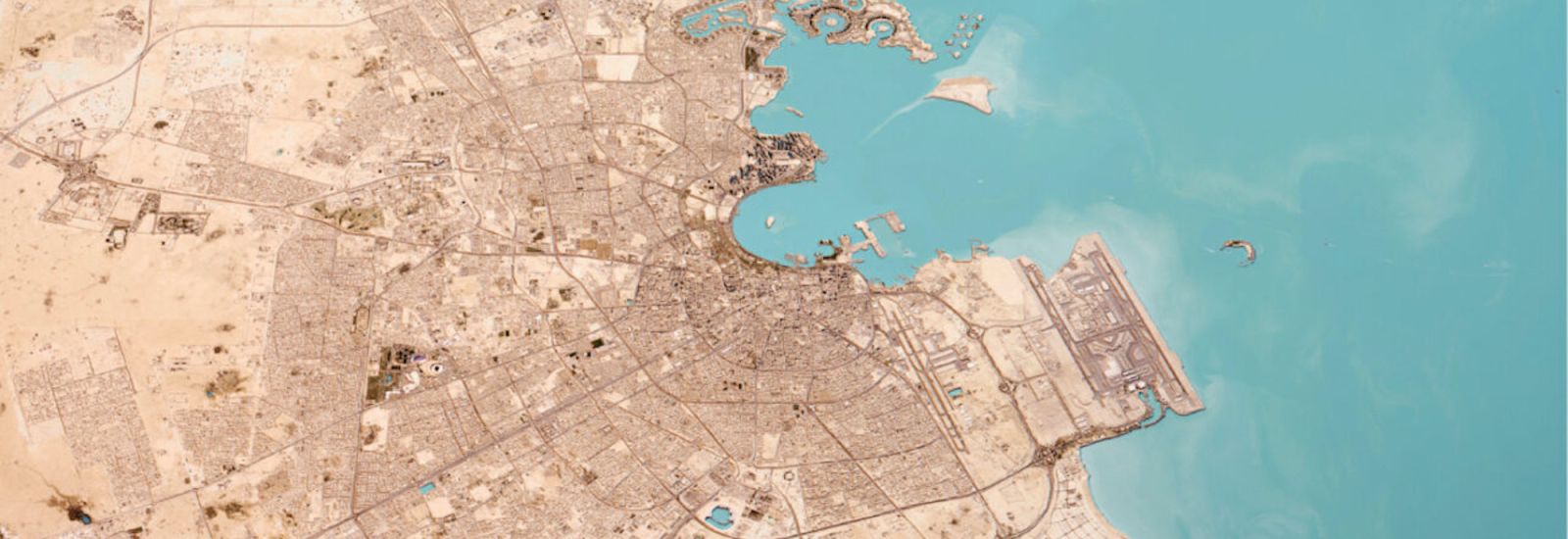 Aerial view of Doha, showing roadways and port