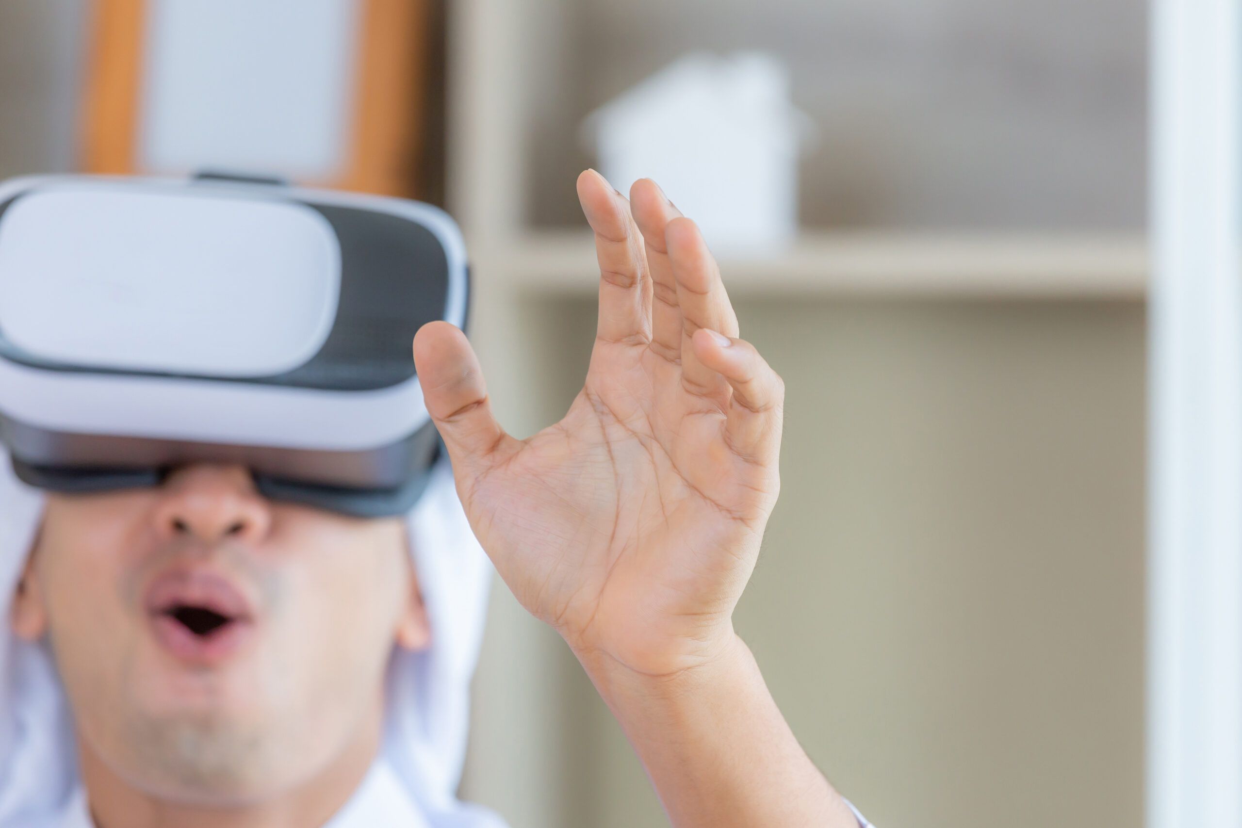 Young Arab business man smiling while experiencing new visual sensations through the virtual reality headset